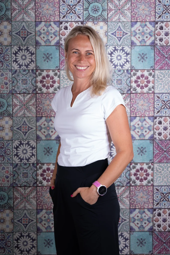 Katerina Hegedüsova, Physiotherapeutin bei Physio Bohemika in Rüti, Portrait vor gemustertem Hintergrund.
